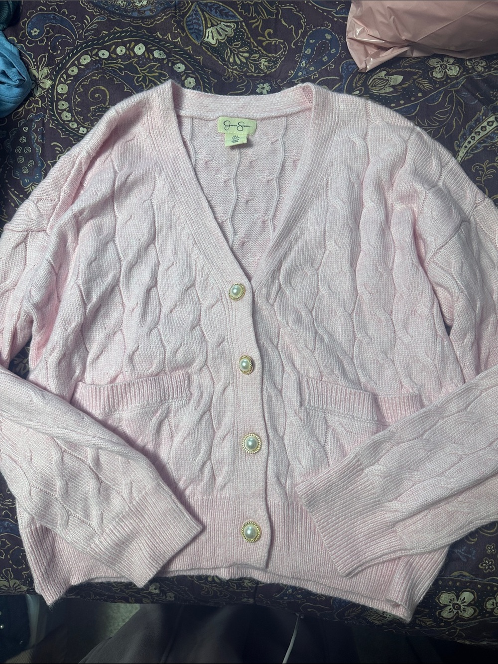 Pink cable knit sweater with pearl buttons